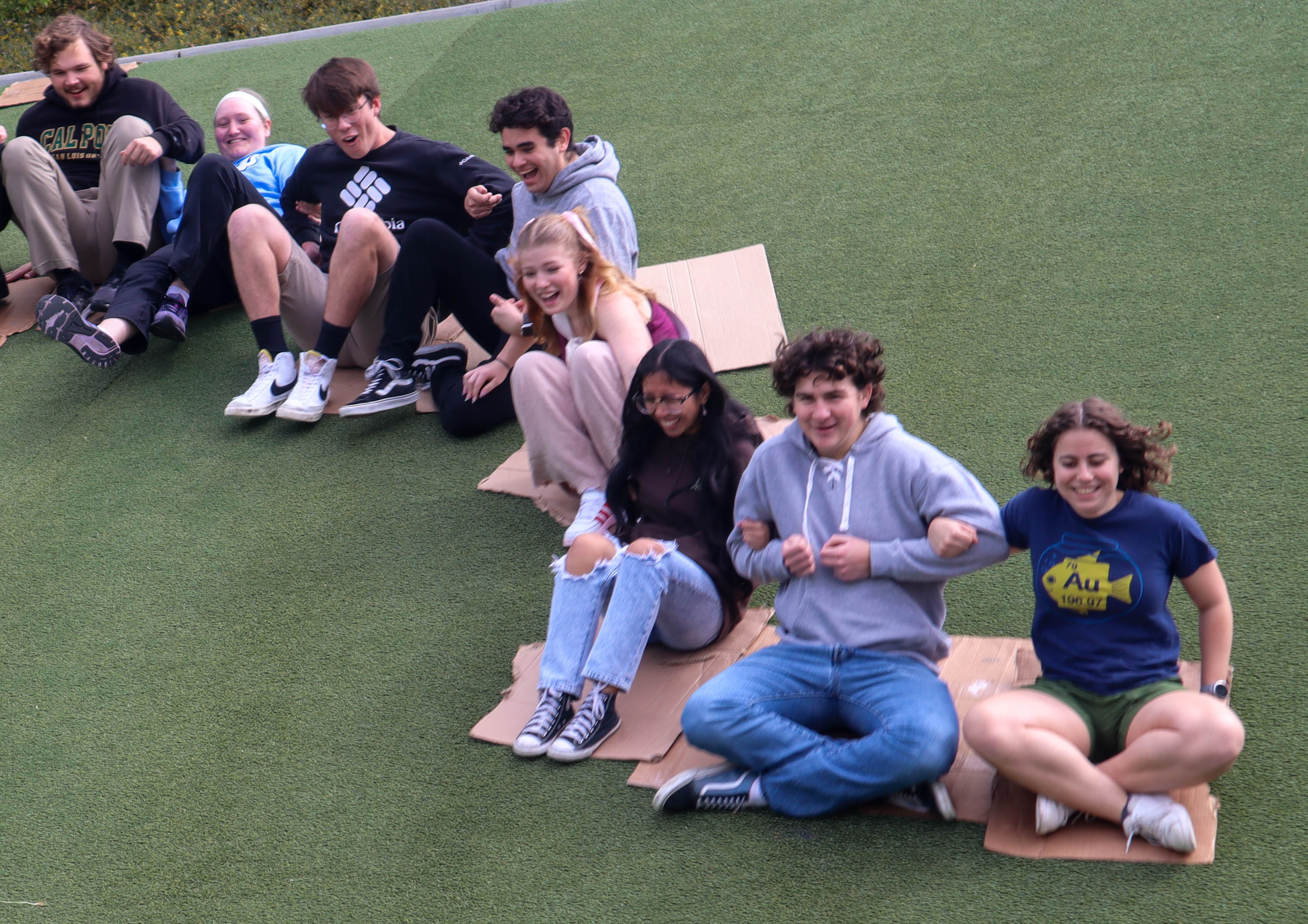 Brothers of Iota Pi sledding in Sinsheimer Park.
